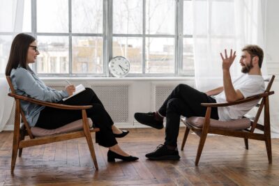 Man talking to woman - mens health Spring budget 2024: Chancellor encourages more people into work